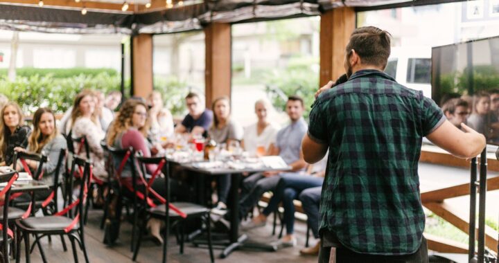 man standing infront of group of people